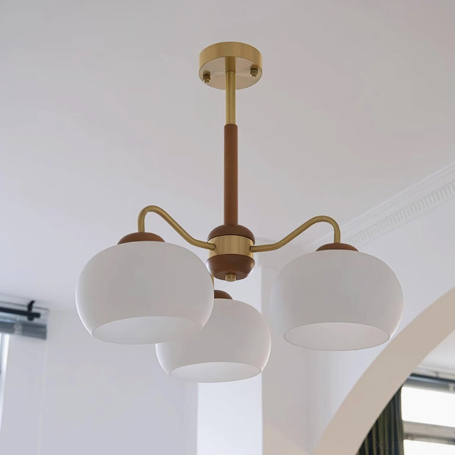 Modern glass chandelier with wooden teak frame and brass hardware details for contemporary interior design