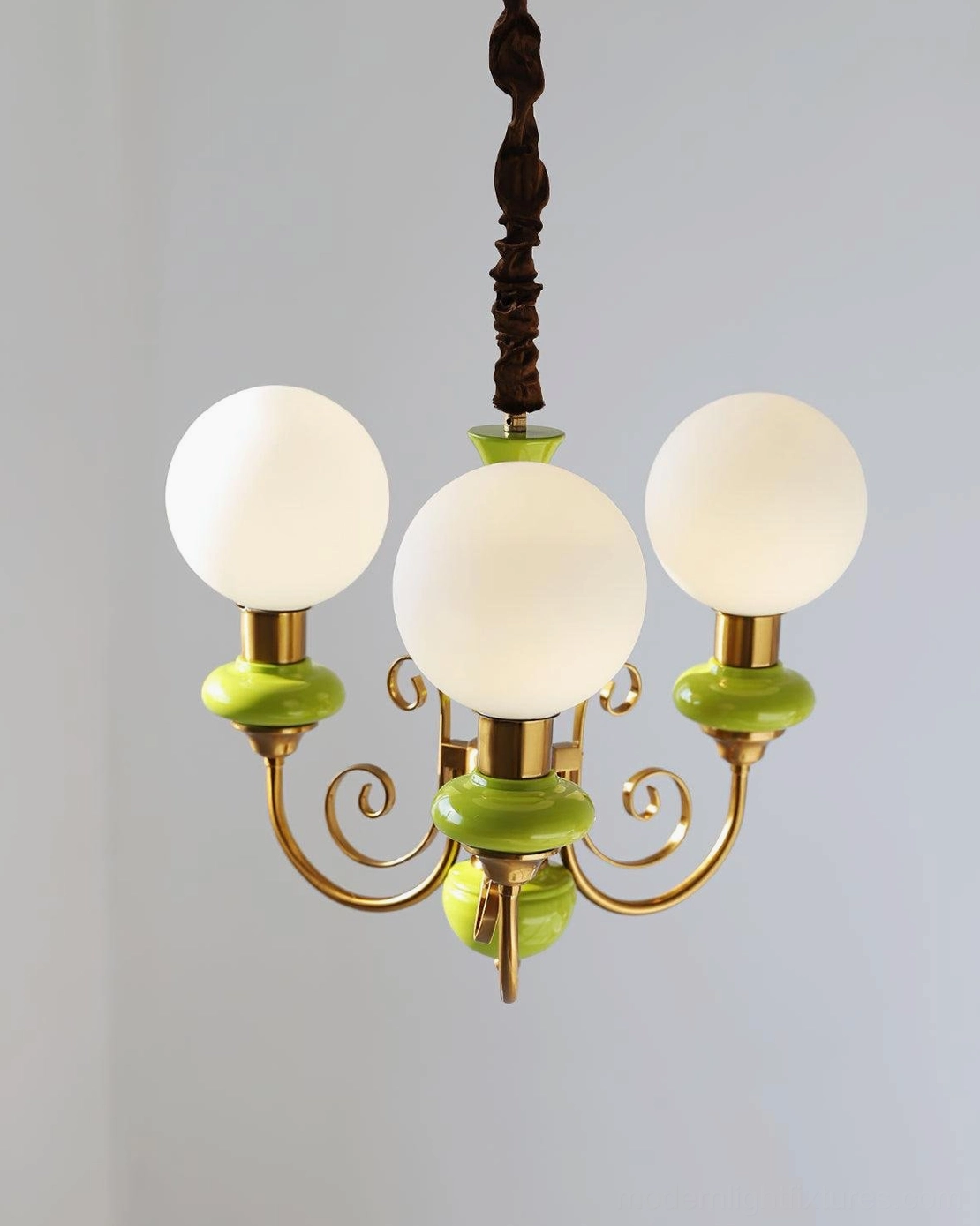 Modern glass chandelier design with warm diffused lighting and elegant metal framing