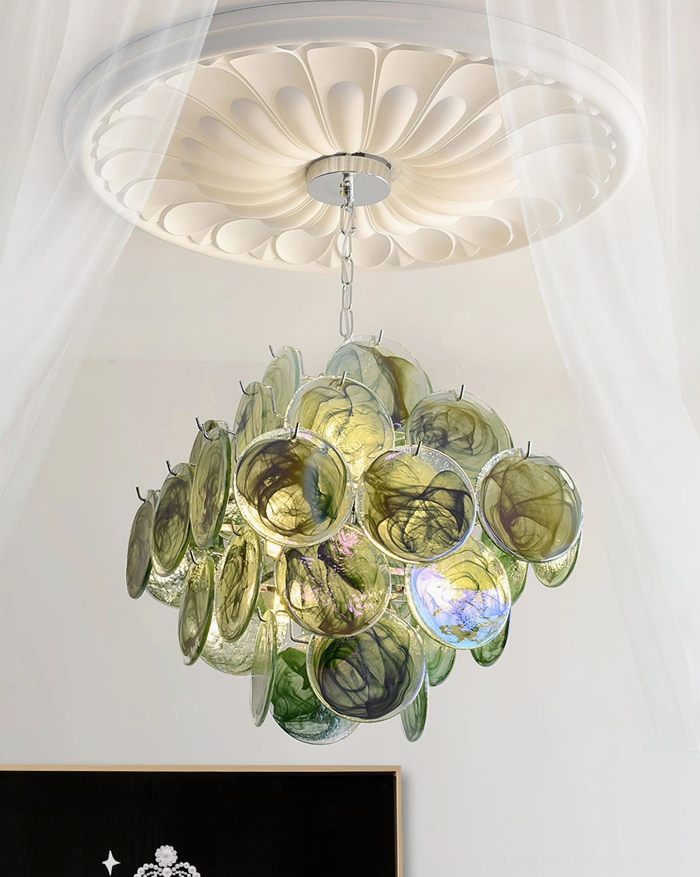 Modern glass disc chandelier installed in elegant dining space showing proportional scale and lighting effect