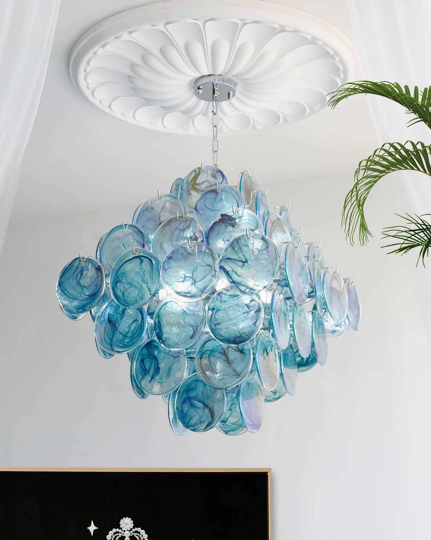 Modern glass disc chandelier evening lighting view showcasing warm glow and atmospheric ambiance creation