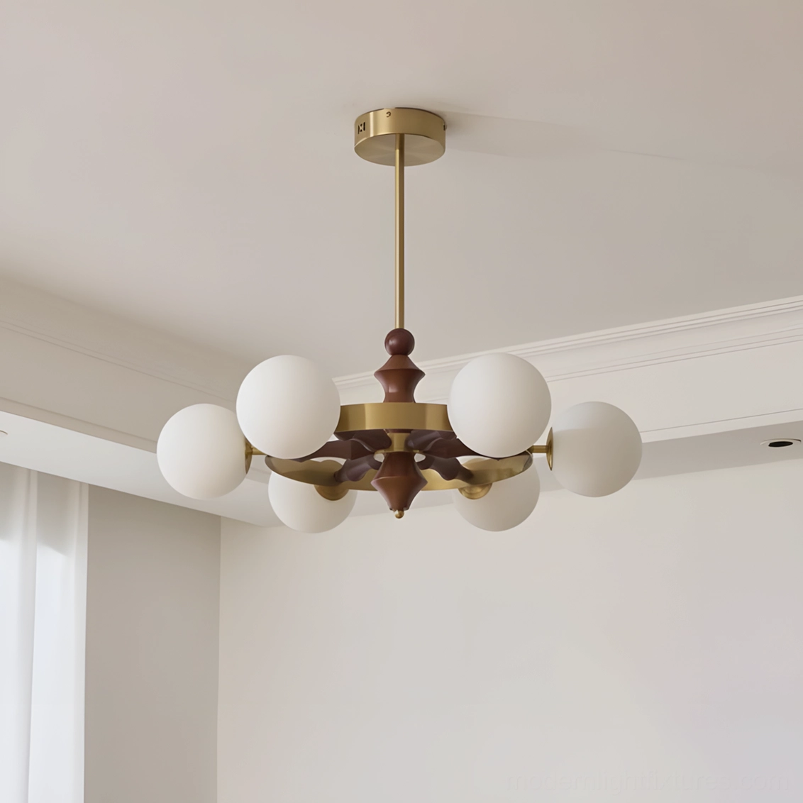 Cream white frosted glass globe chandelier with brass frame on white studio background minimalist design