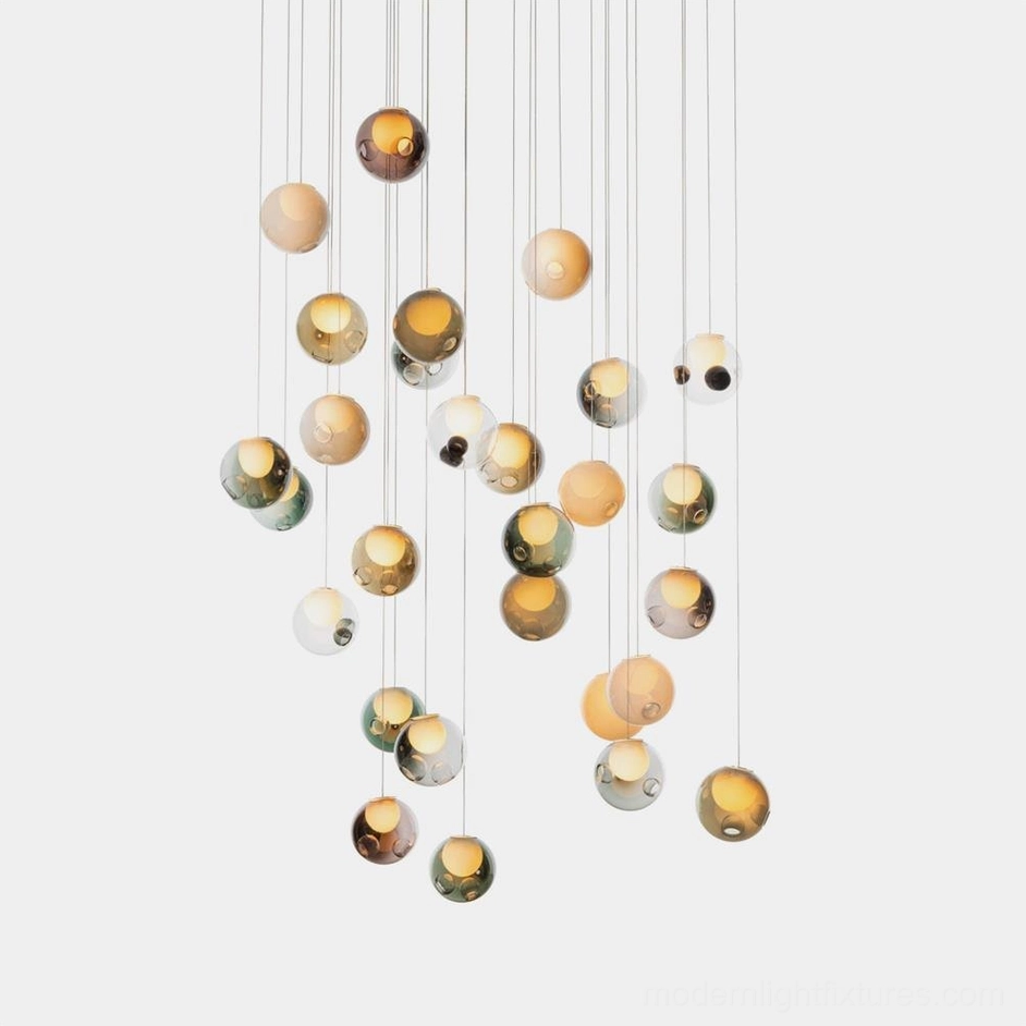 Hand-blown glass globe cluster chandelier with multiple clear glass orbs in modern minimalist style, studio photography