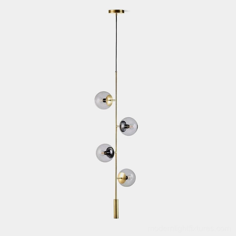 Modern glass orb chandelier with brass accents and multiple hanging glass spheres, studio product view