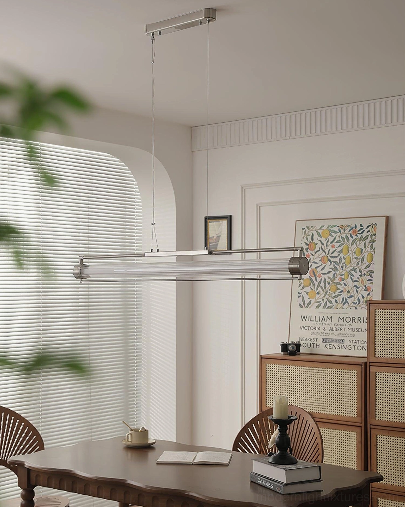 Unlit clear glass linear pendant fixture in mid-century dining room - sand nickel accents with neutral home decor