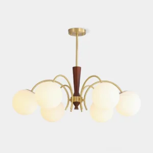 Modern 8-head globe chandelier with brass frame and frosted milk glass shades, front view against studio backdrop