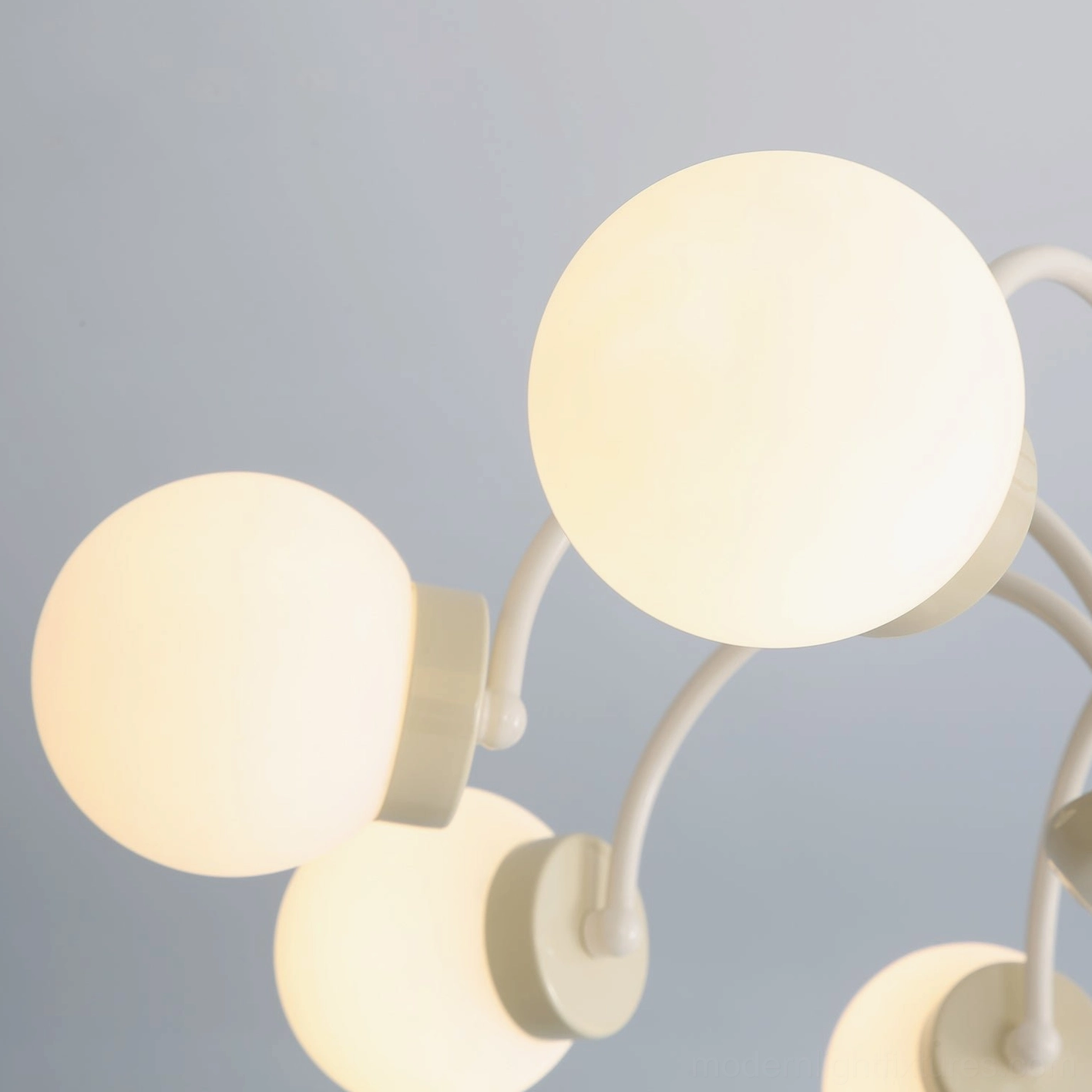 Modern globe chandelier assembly, glass spheres and metal arms construction detail