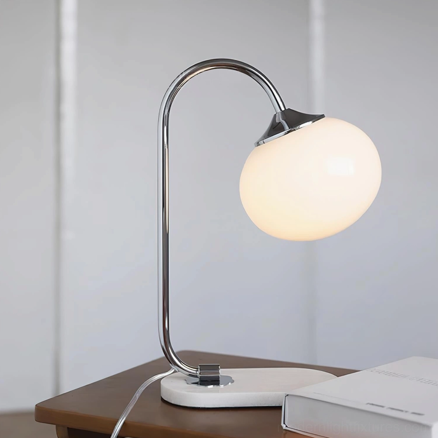 Modern globe table lamp with white marble base and curved metal arm complete product view