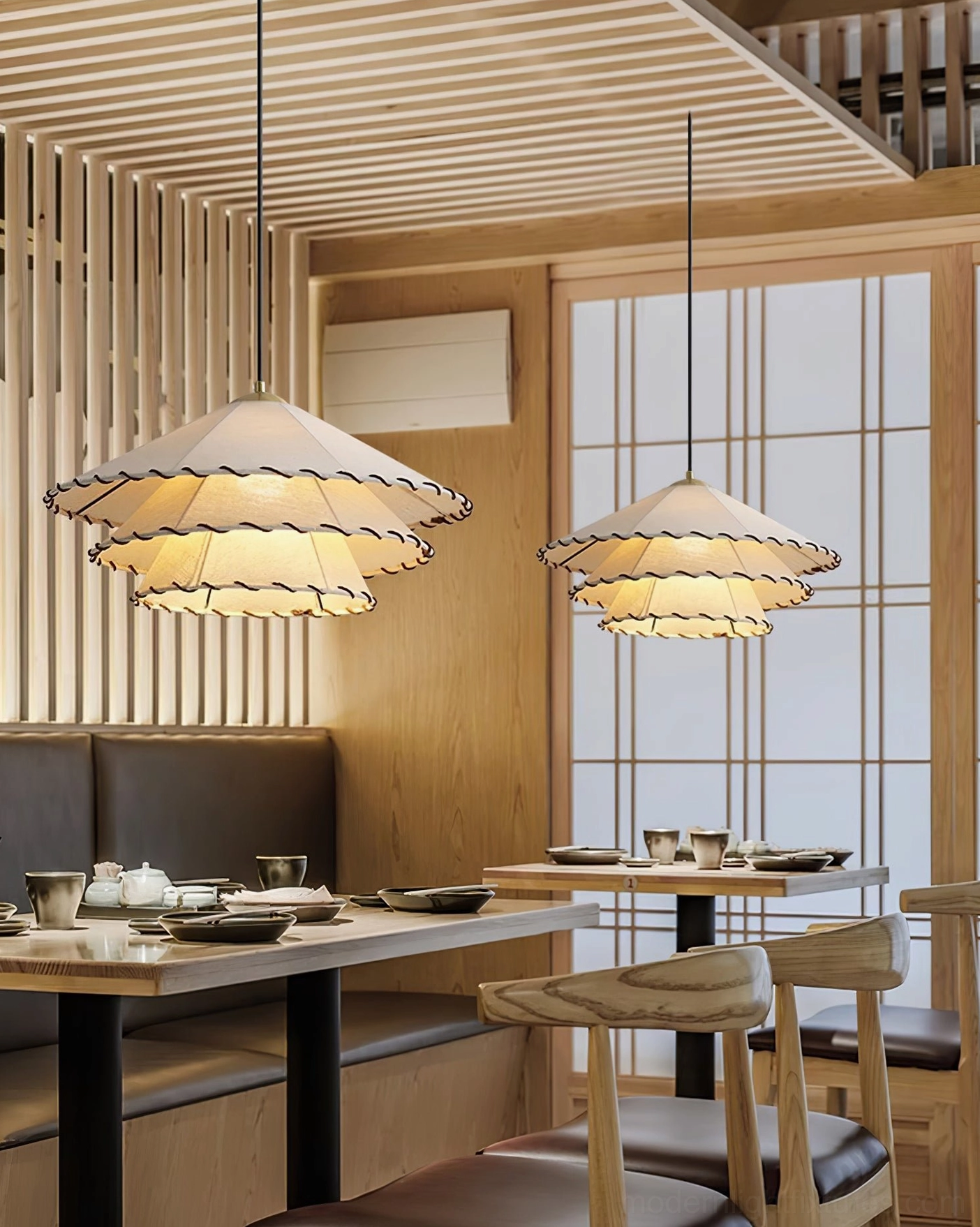 Modern handmade fabric pendant light with beige ruffled shade suspended in minimalist living space