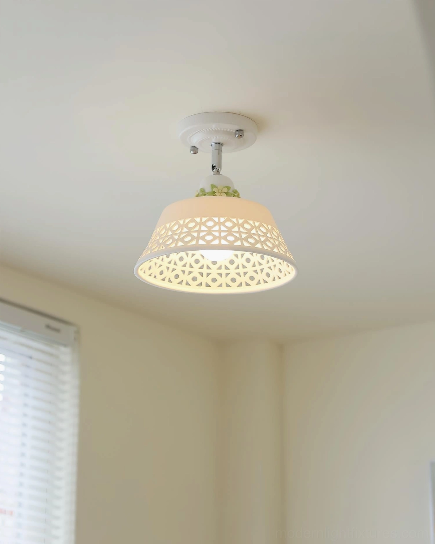 Modern hollow carved ceiling fixture with intricate geometric patterns and warm glowing illumination