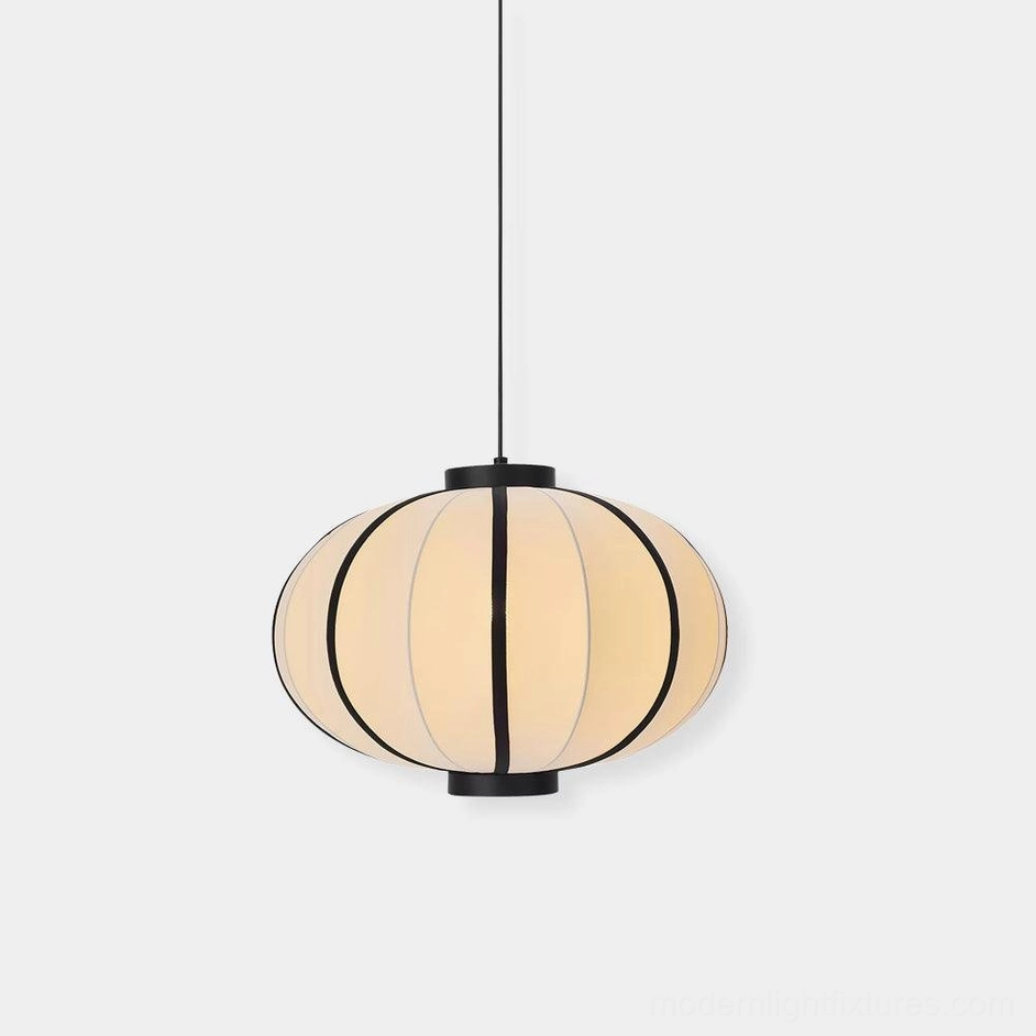 Modern geometric lantern pendant light with black and white fabric shade, front studio view