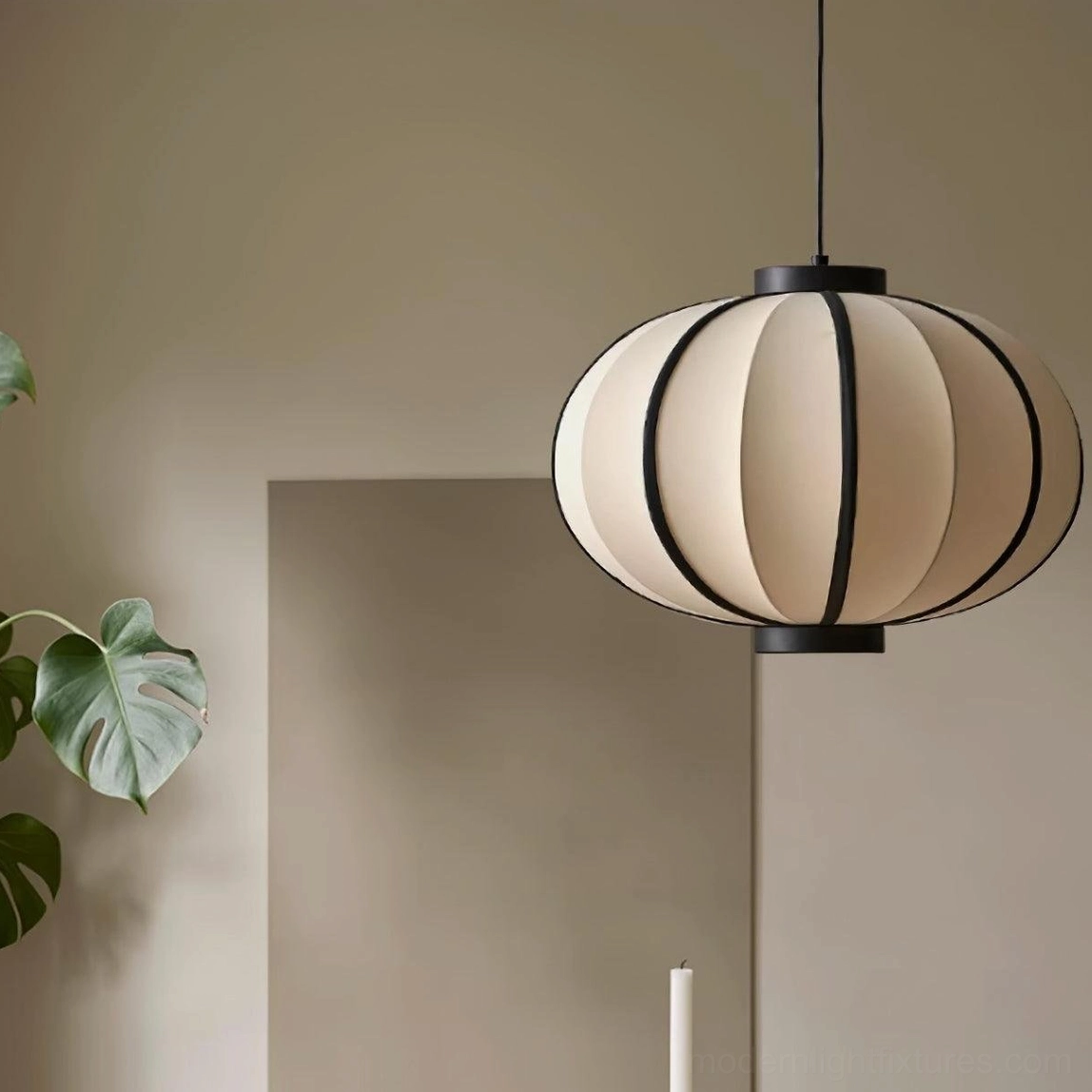 Contemporary geometric pendant light in minimalist living room with green plant decor