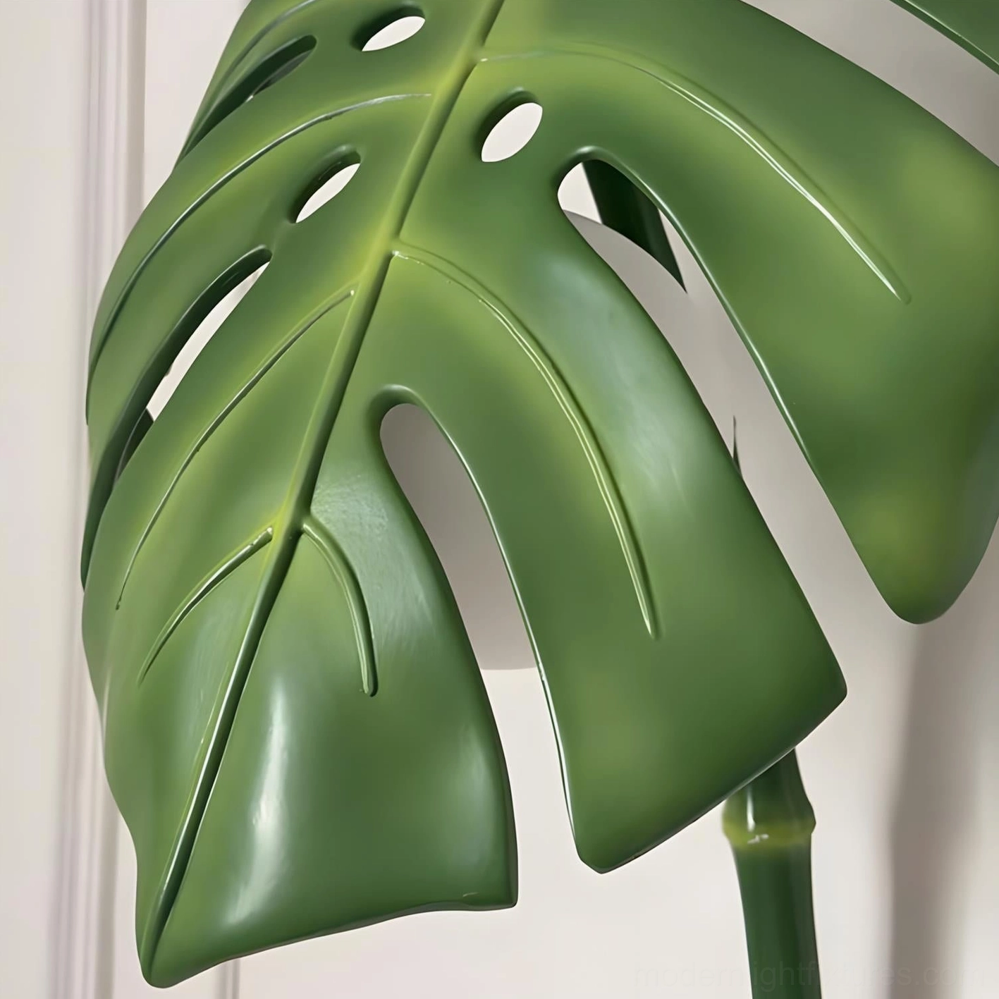 Modern leaf wall lamp mounted in bedroom or home office creating botanical aesthetic