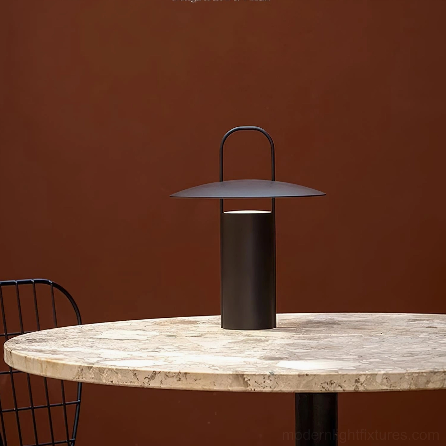 Matte brown contemporary LED table lamp placed on outdoor marble dining table setting