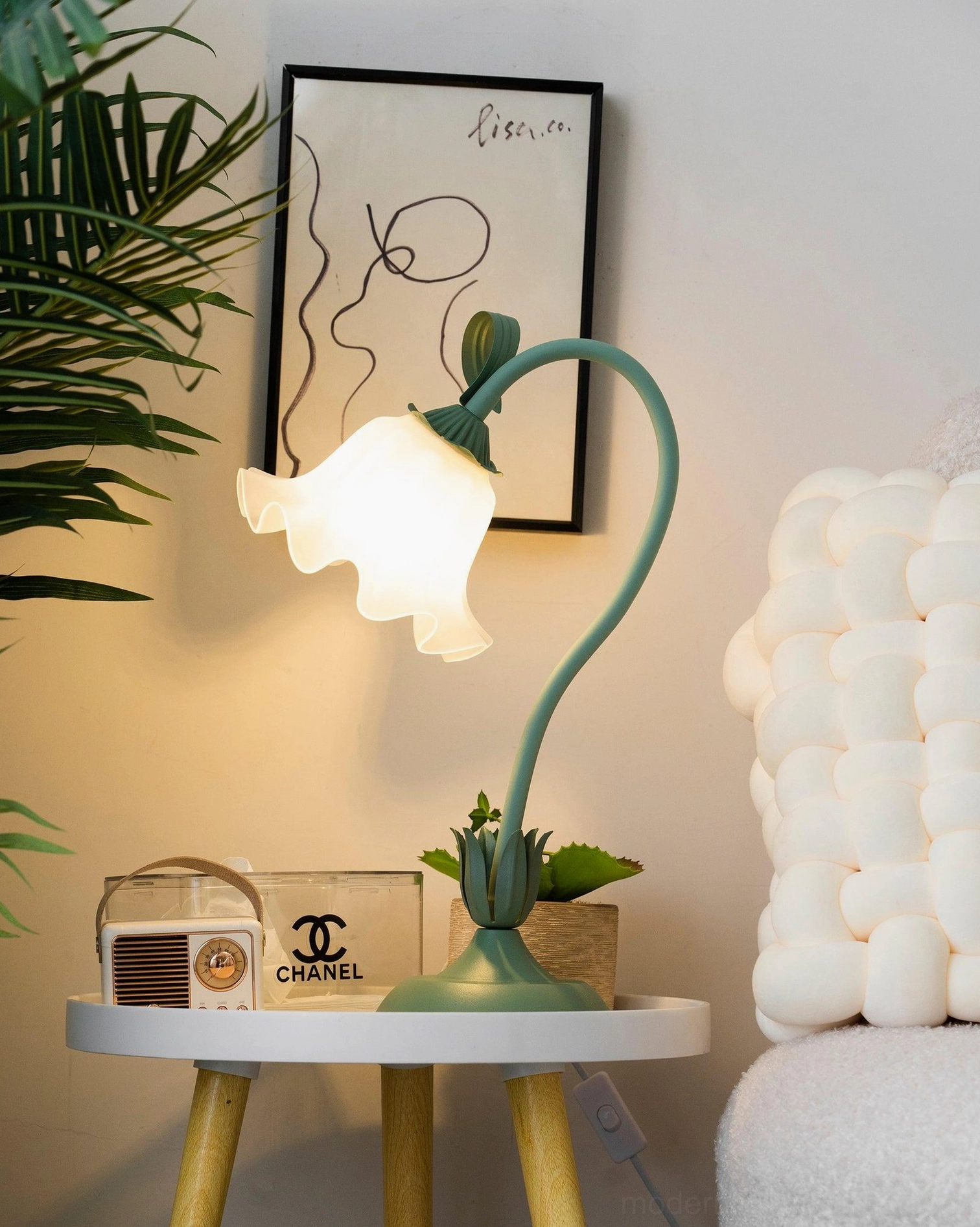 Modern lily flower table lamp showing sculptural floral shade design in home setting