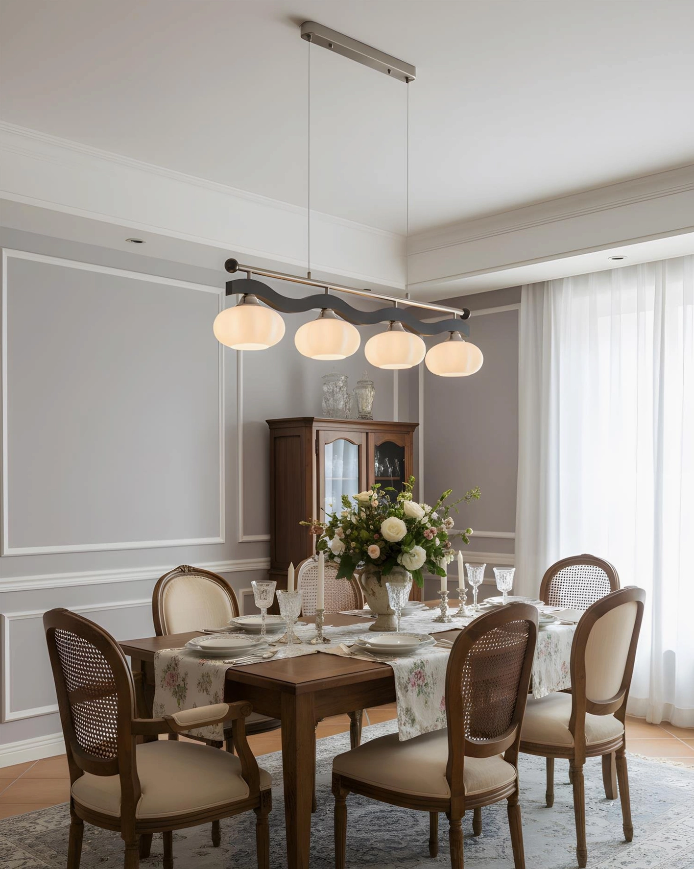 Modern linear pendant chandelier with 4 heads glowing frosted glass shades and dual-tone metal frame in contemporary dining room