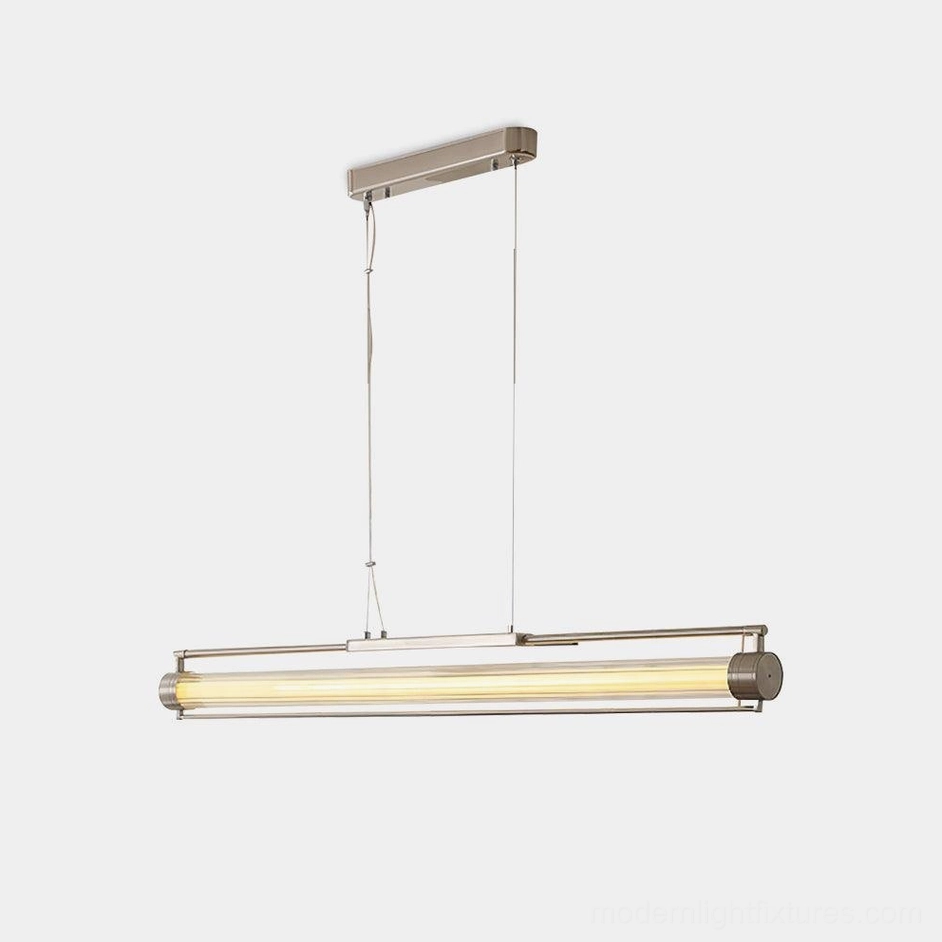 Modern linear LED pendant light with clear glass tube and sand nickel metal hardware - minimalist design studio view