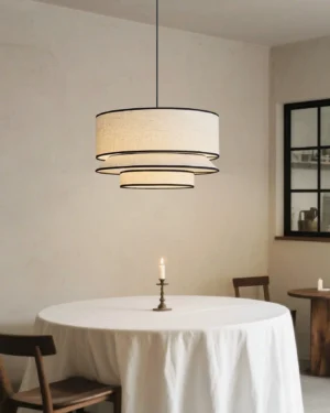 Circlune fabric pendant lamp illuminated above round dining nook with warm ambient glow