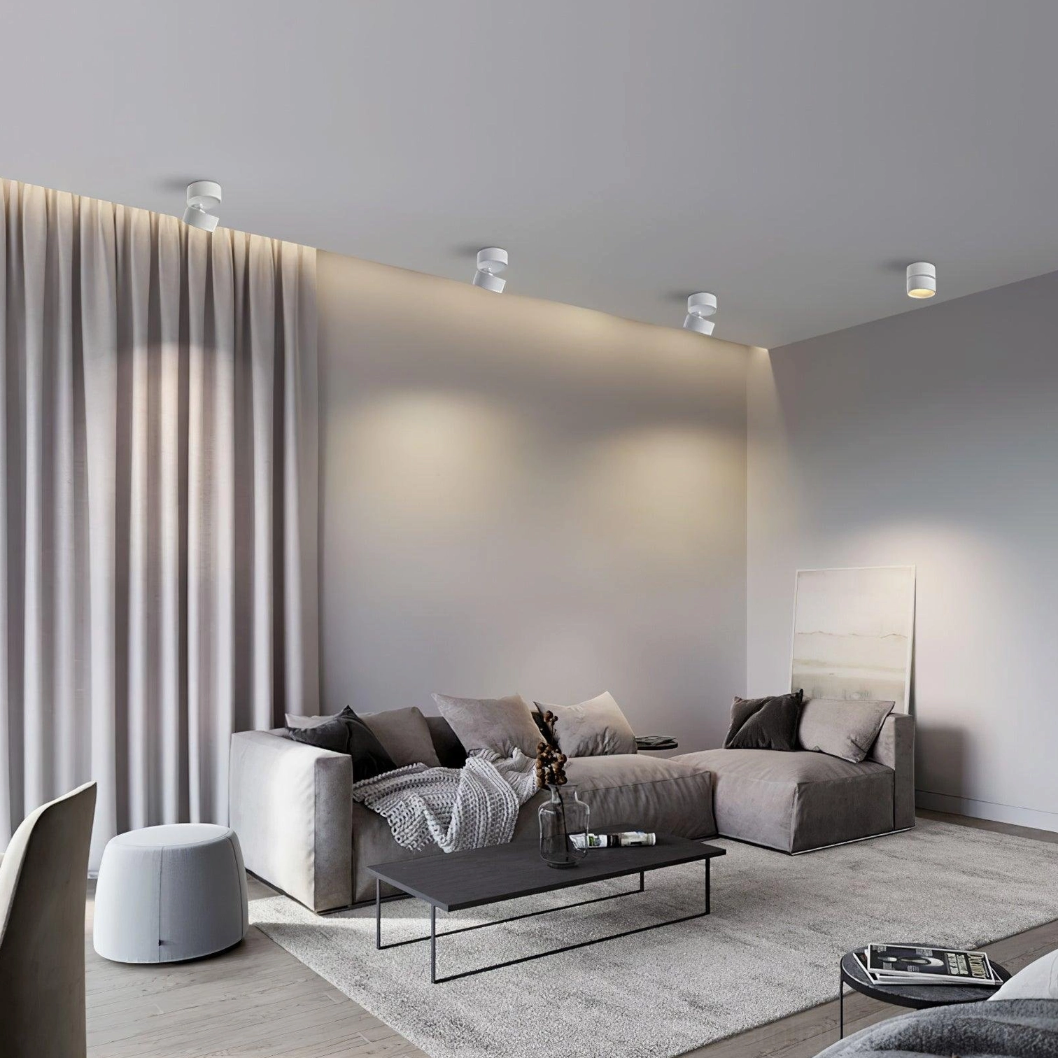 Multiple white surface mounted spotlights installed on ceiling in modern minimalist living room with warm ambient lighting