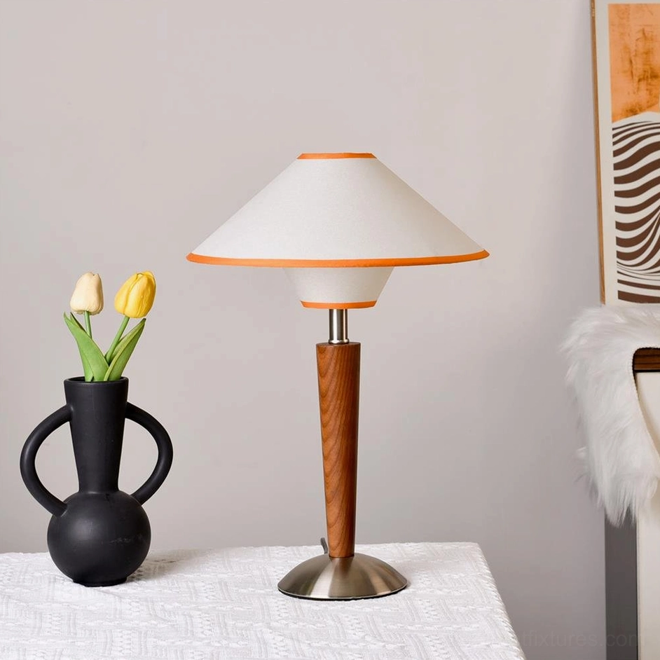 Contemporary table lamp with brushed stainless steel base and fabric shade, styled with black vase and yellow tulip flowers