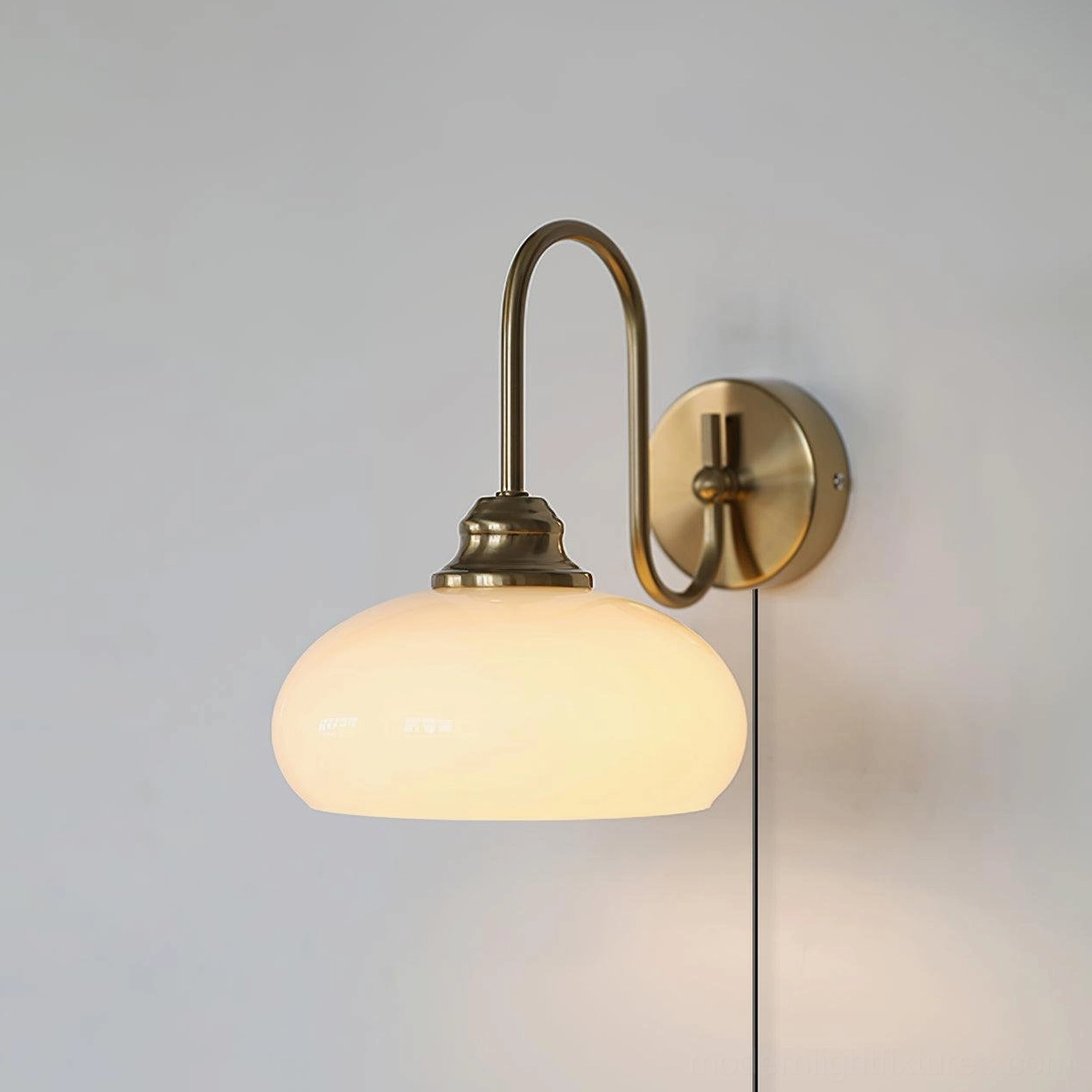 Modern mid-century plug-in wall light with chrome base and frosted glass diffuser, installed in hallway with soft layered lighting