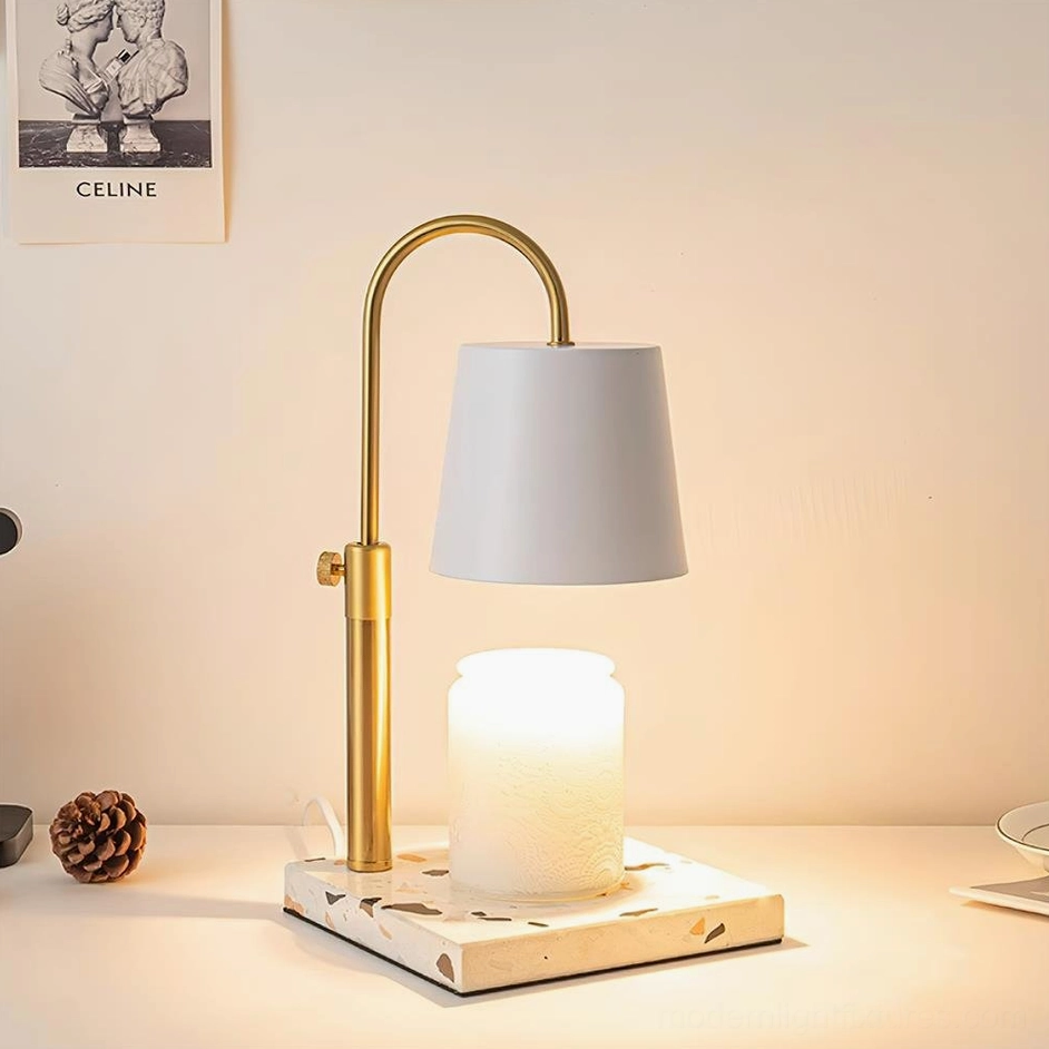 Modern minimalist candle warmer lamp with sculptural brass gold arm and fabric shade