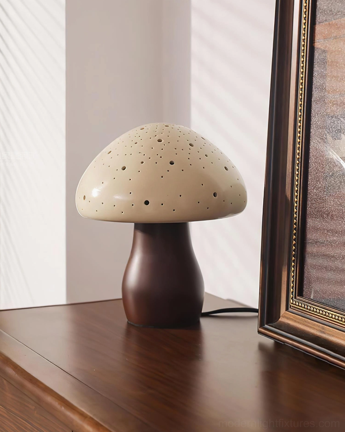 Modern sculptural mushroom table lamp on bedroom nightstand with soft diffused light and dark wood base