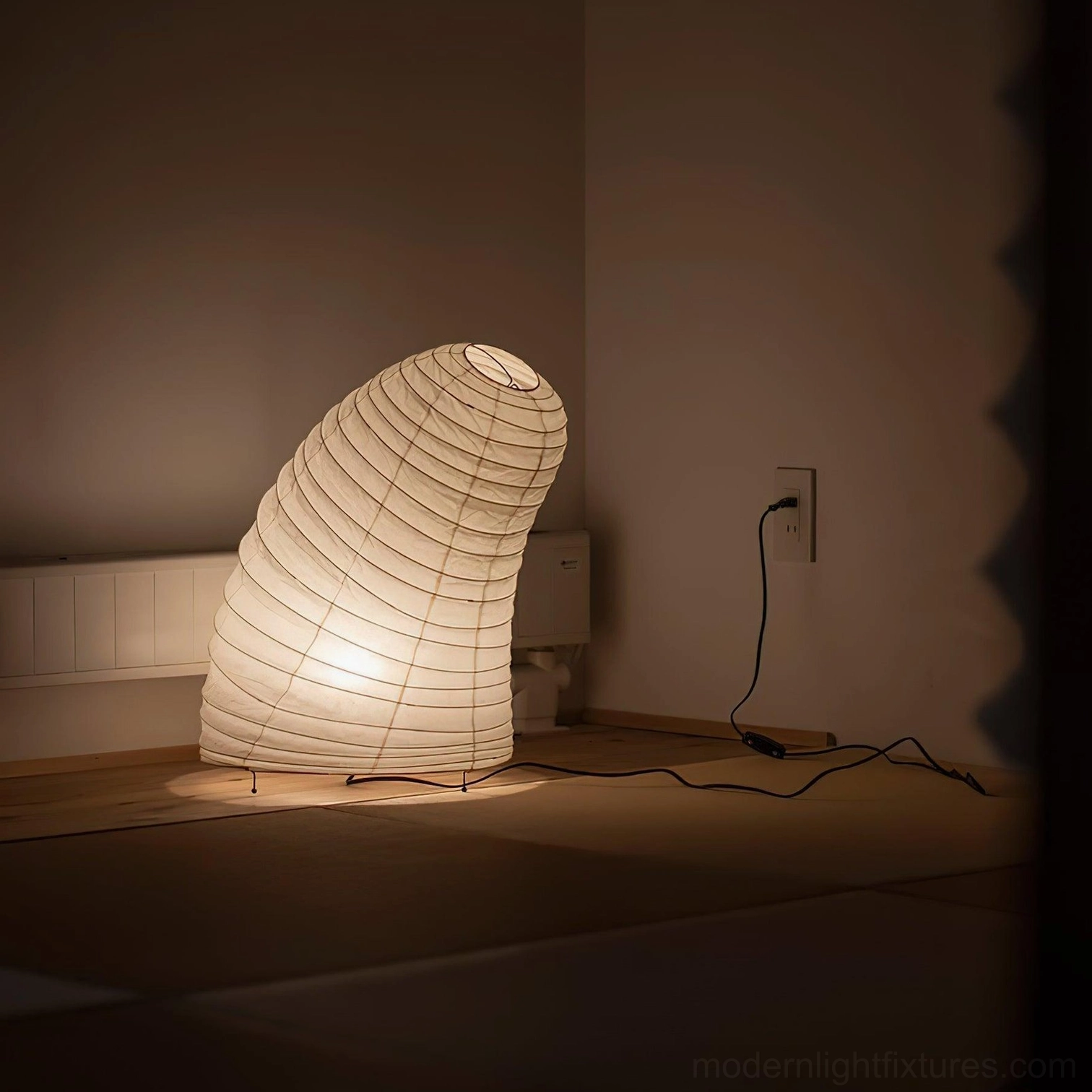 Modern paper table lamp in Japanese minimalist bedroom warm ambient light black power cord