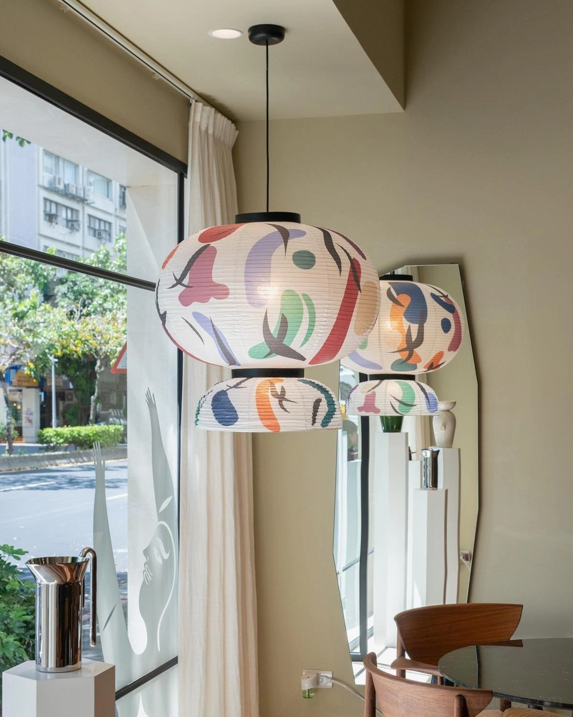 Modern paper pendant lamp with cultural heritage inspired design combining traditional lantern form with contemporary abstract artistry