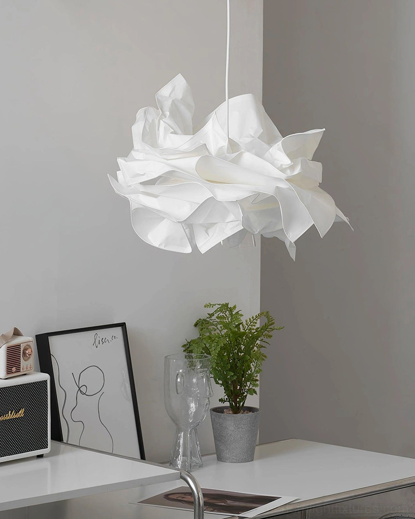 Organic folded paper pendant lamp with minimalist aesthetic in contemporary home office workspace