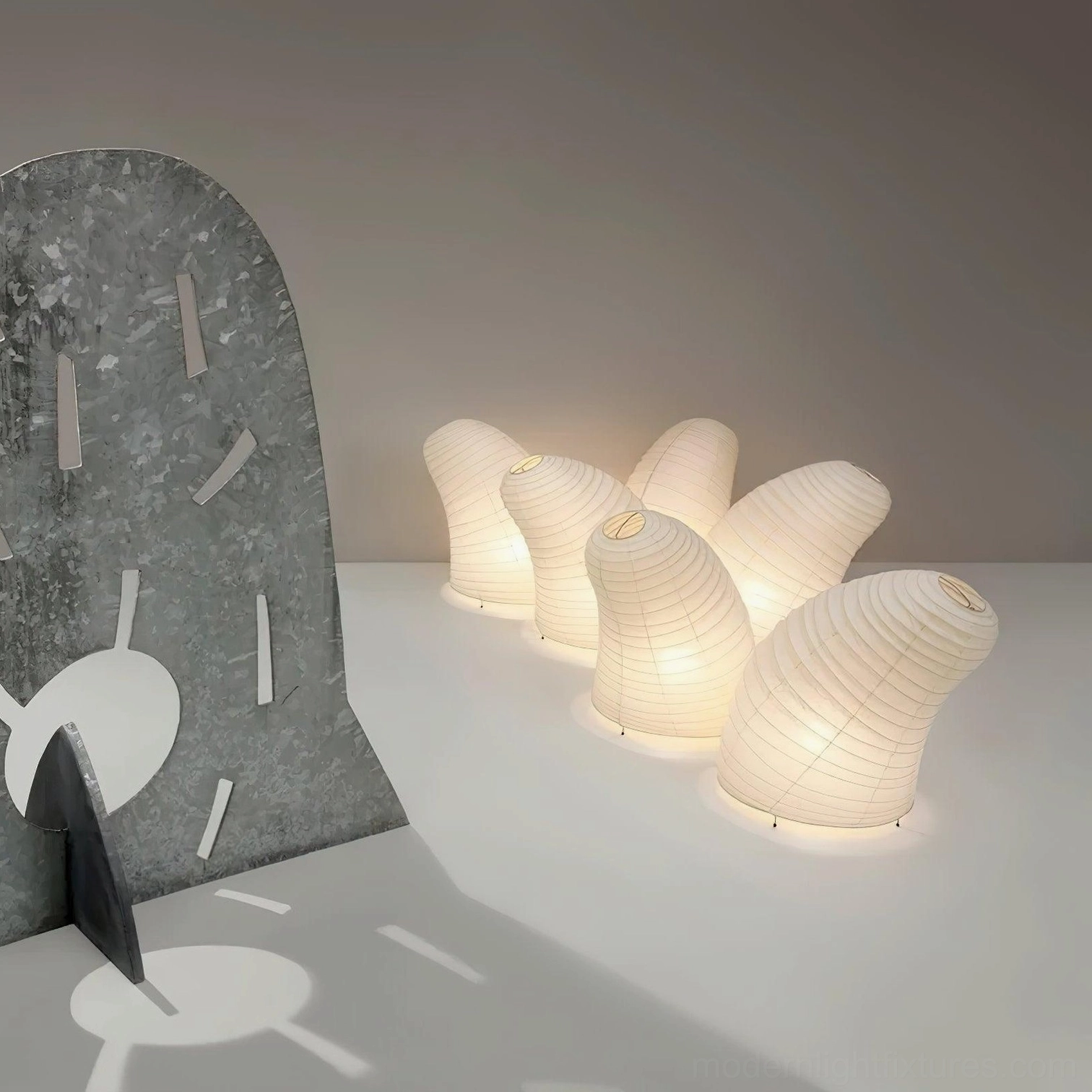 Set of matching modern paper table lamps displayed together in contemporary interior setting overhead view