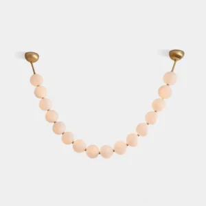 Modern pearl string chandelier with frosted acrylic spheres and brass hardware in U-shaped configuration