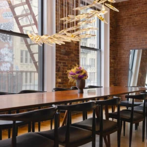 Luxury pendant chandelier installed in contemporary dining room with industrial loft design