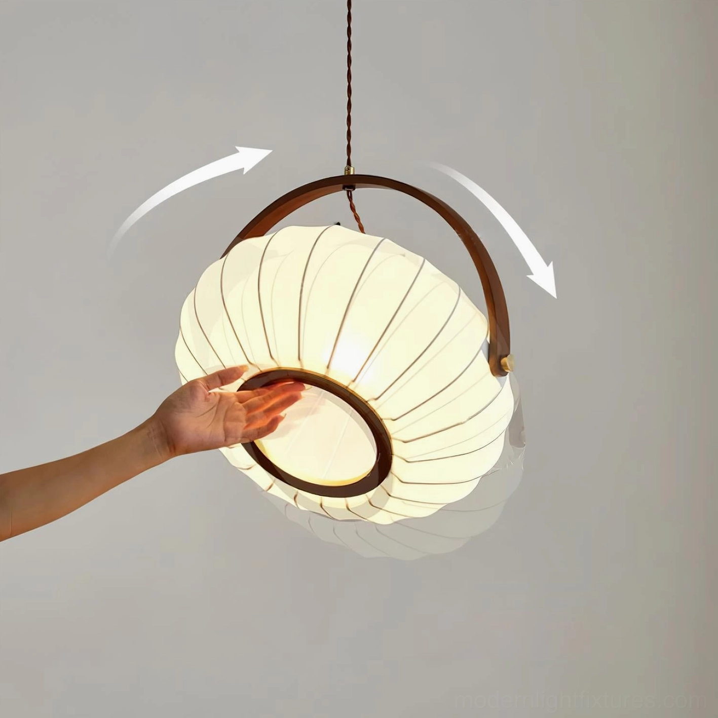 Adjustable fabric shade pendant lamp demonstrating hand-operable pleated design feature