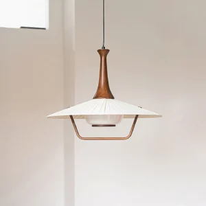 Modern walnut wood pendant lamp three-quarter angle showing brass metal frame and folded fabric shade