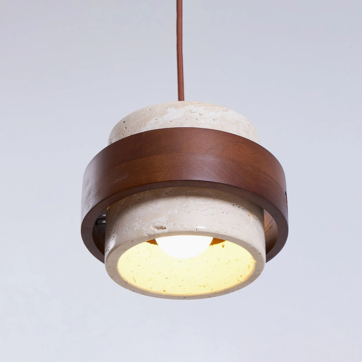 Modern pendant lamp with genuine travertine stone shade, contemporary minimalist design in neutral interior