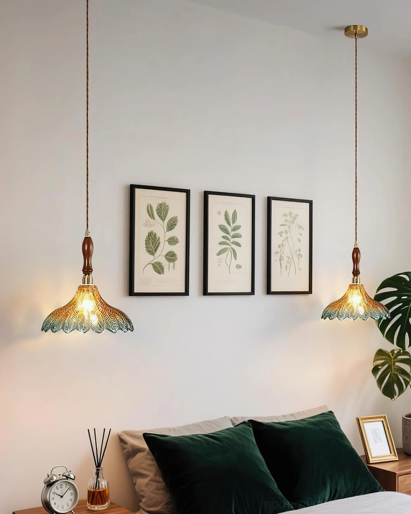 Modern pendant light with blue jewel-toned glass shade and walnut wood stem in contemporary interior