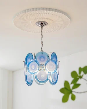 Contemporary pendant light installed on ceiling showing decorative chrome medallion and geometric glass disc arrangement