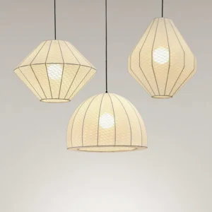 Modern pendant light collection showing multiple geometric shapes with warm fabric diffuser, overhead perspective