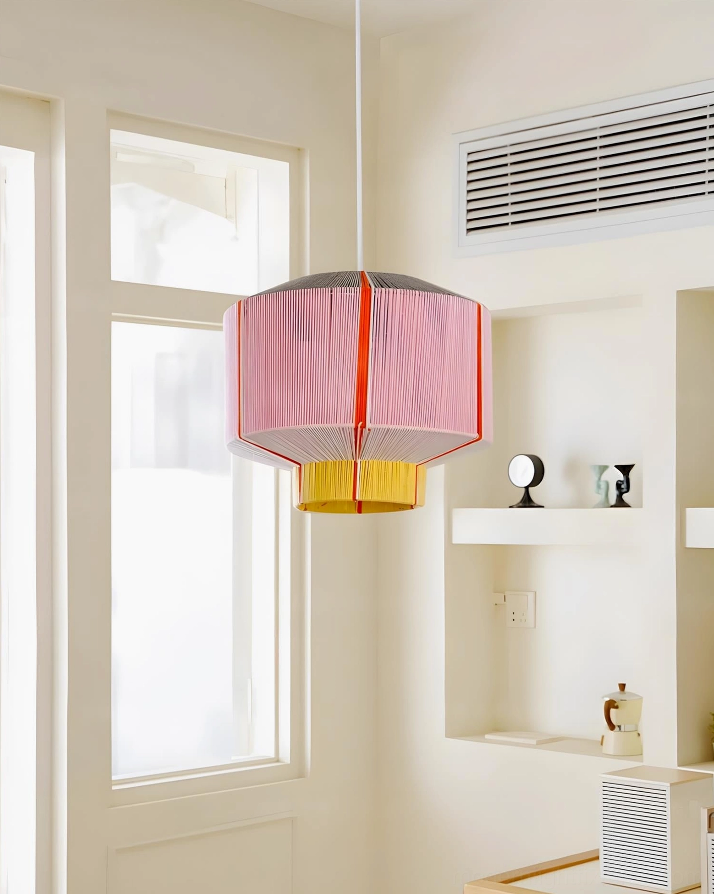 Contemporary faceted pendant lamp in styled interior showcasing light diffusion through cotton thread pleats