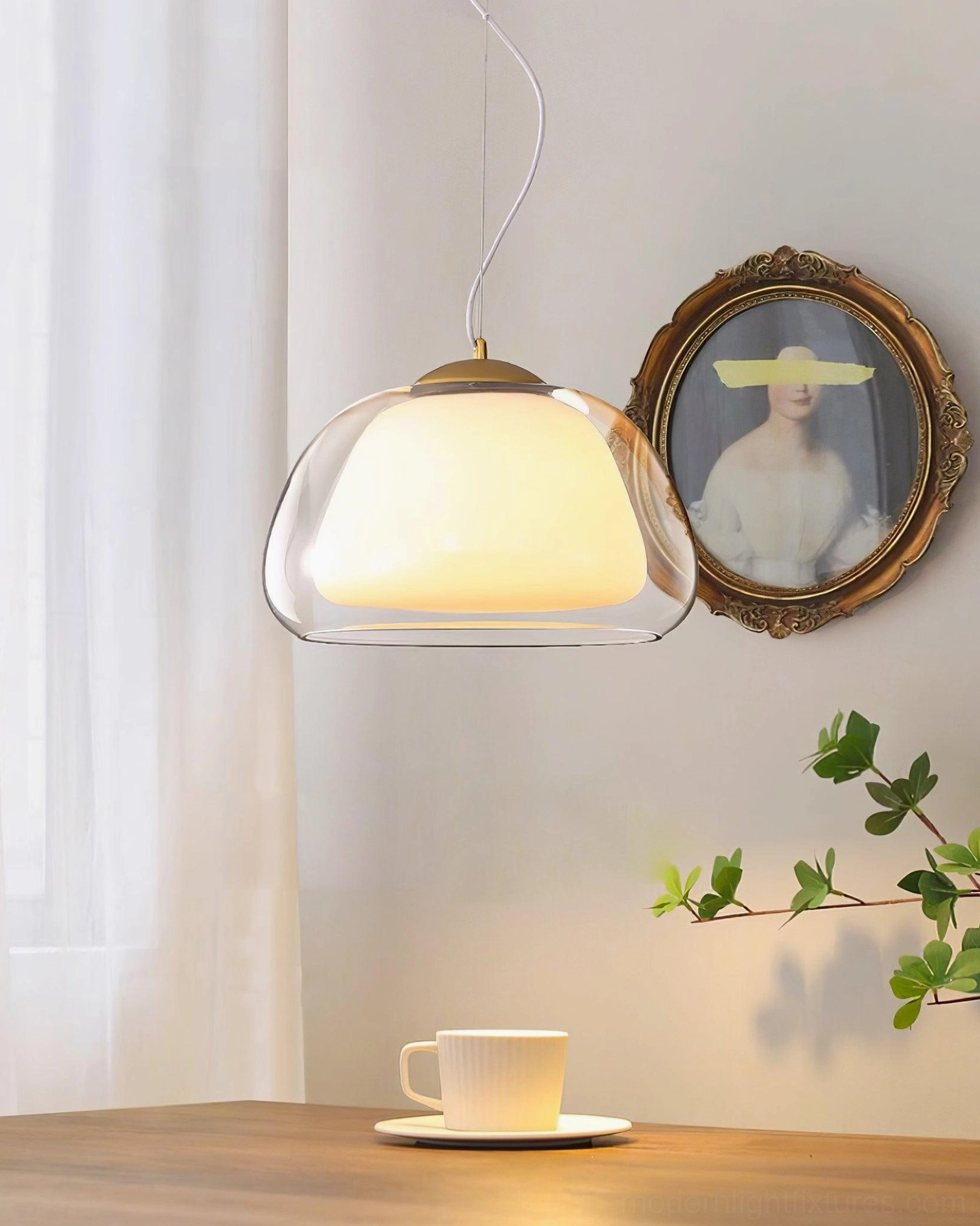 Minimalist glass pendant light in vintage french dining room with wooden table and botanical décor