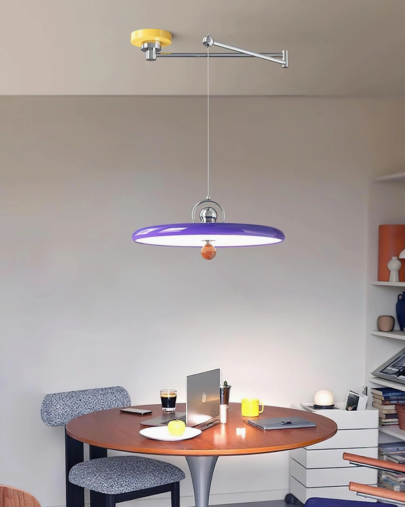 Contemporary swing arm pendant light installed in modern dining room above table, purple disc shade creating ambient focal point