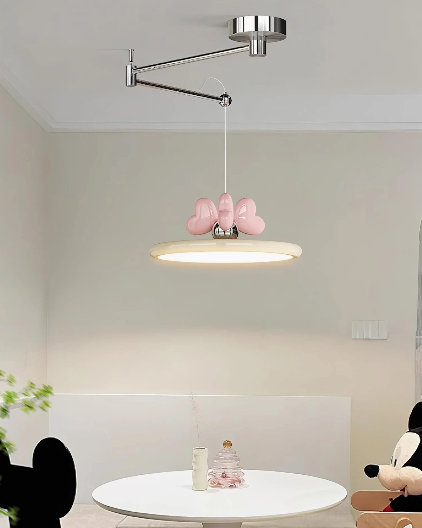 Modern pendant light installed above dining table showcasing adjustable swing arm and decorative appeal