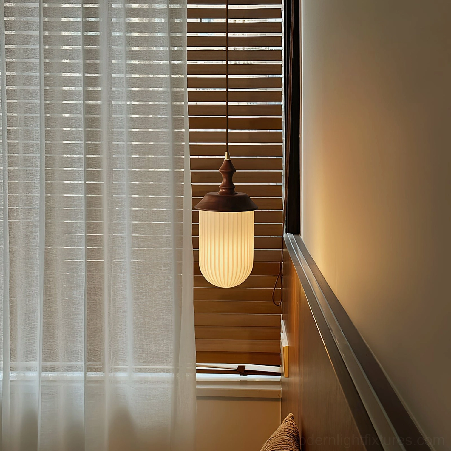 Modern pendant light in hallway corridor with sheer curtains and wooden blinds creating warm ambient glow
