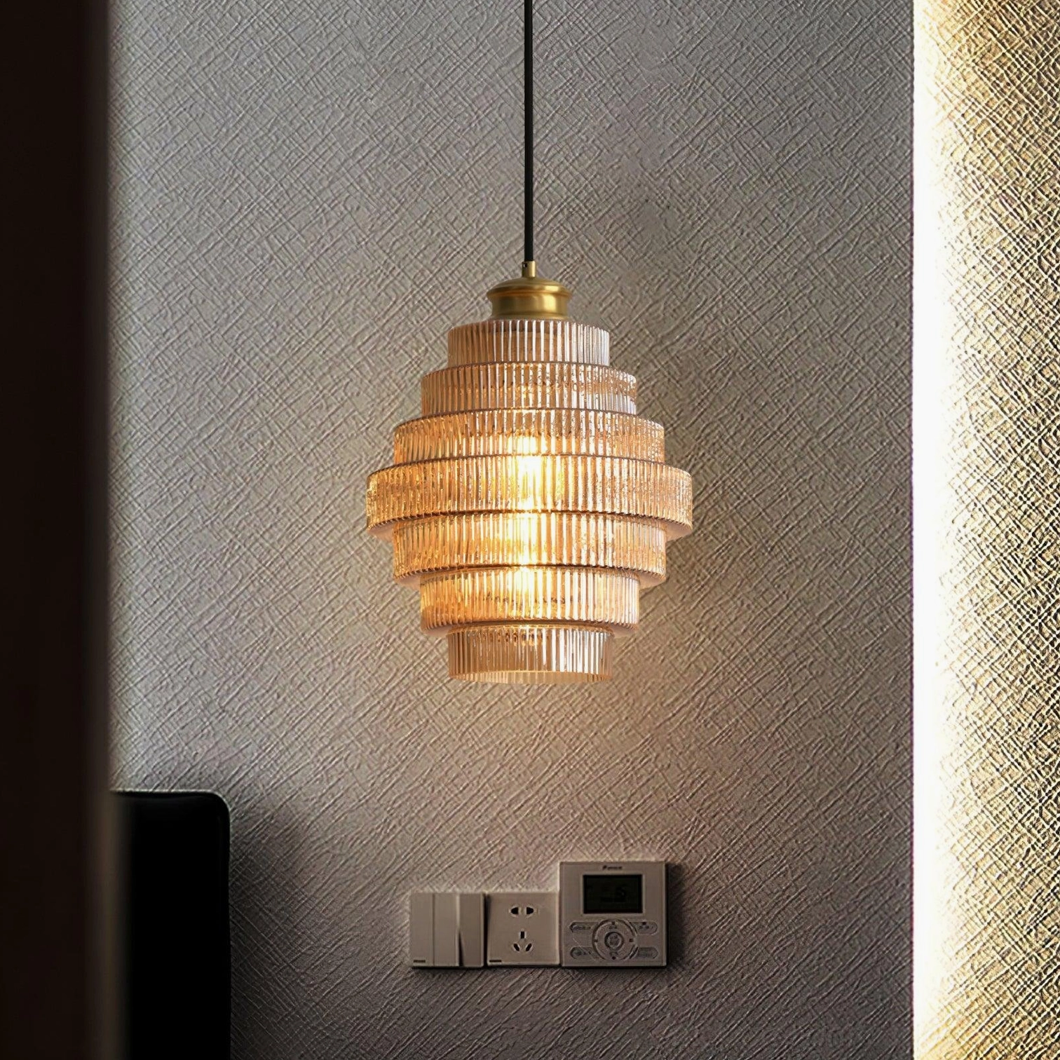 Modern pendant light installation with ridged amber glass, kitchen island lighting application