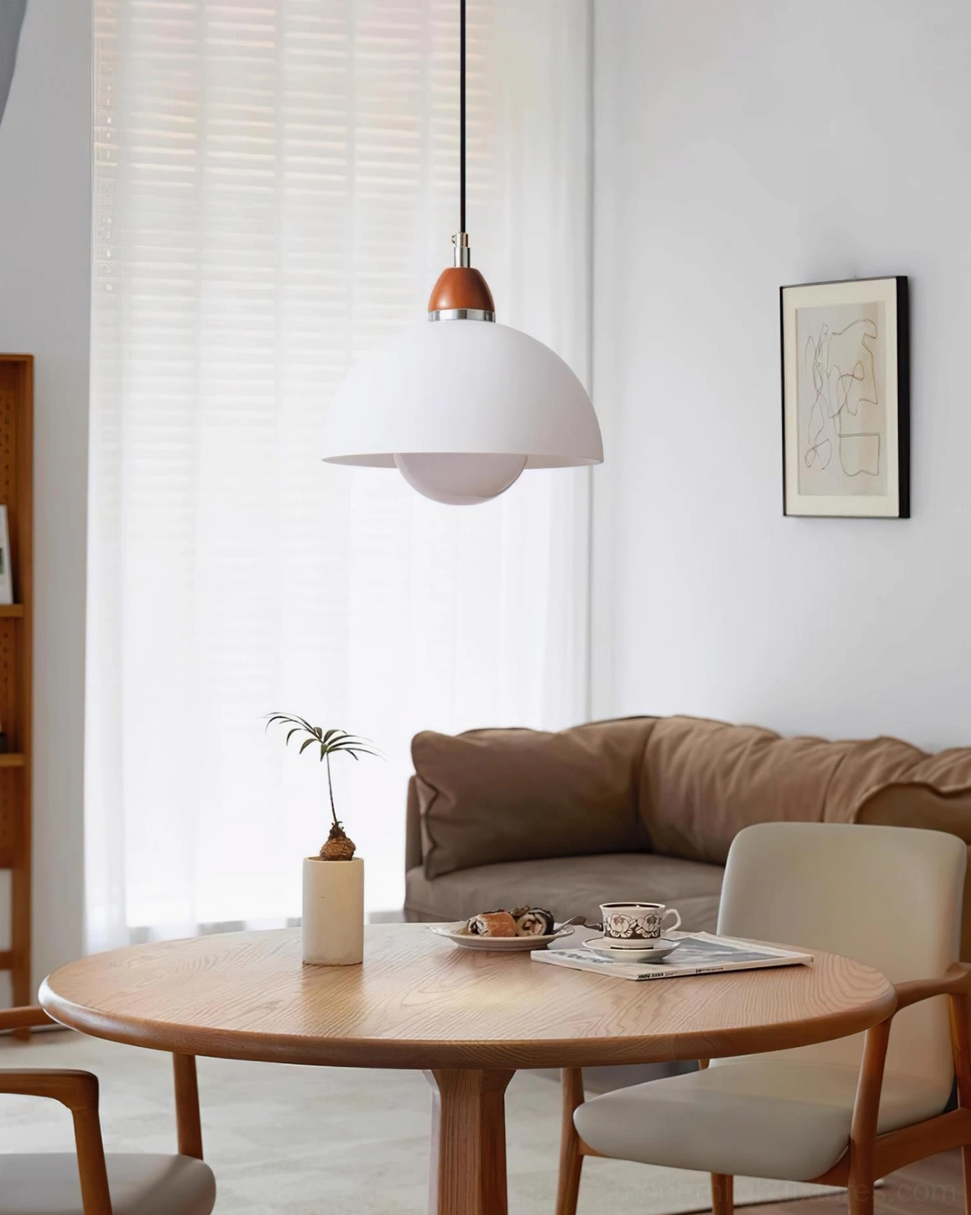 Domed pendant light in contemporary living dining room, white matte shade with wooden accents over round table