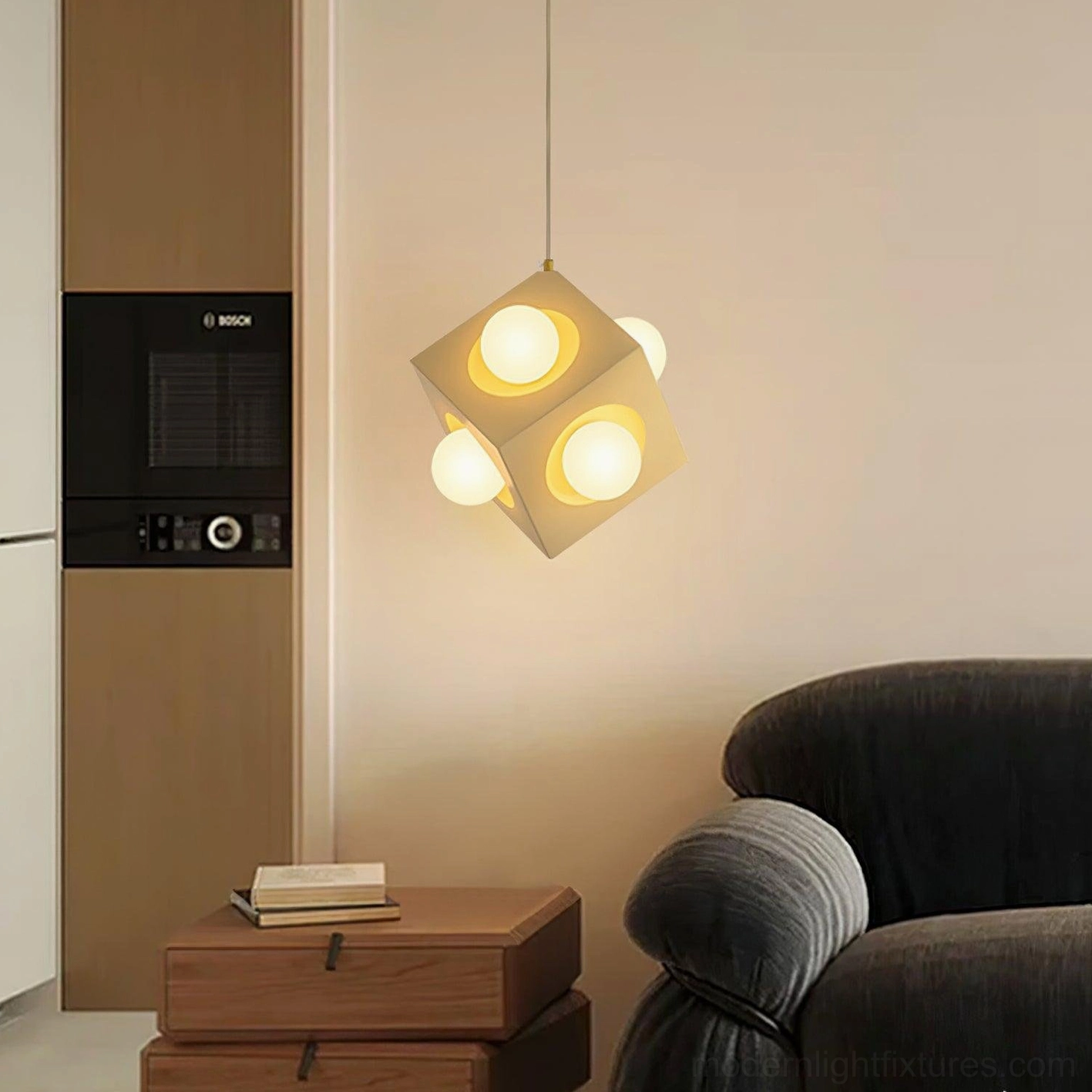 Modern geometric pendant fixture above side table in minimalist lounge with dark sofa and warm lighting