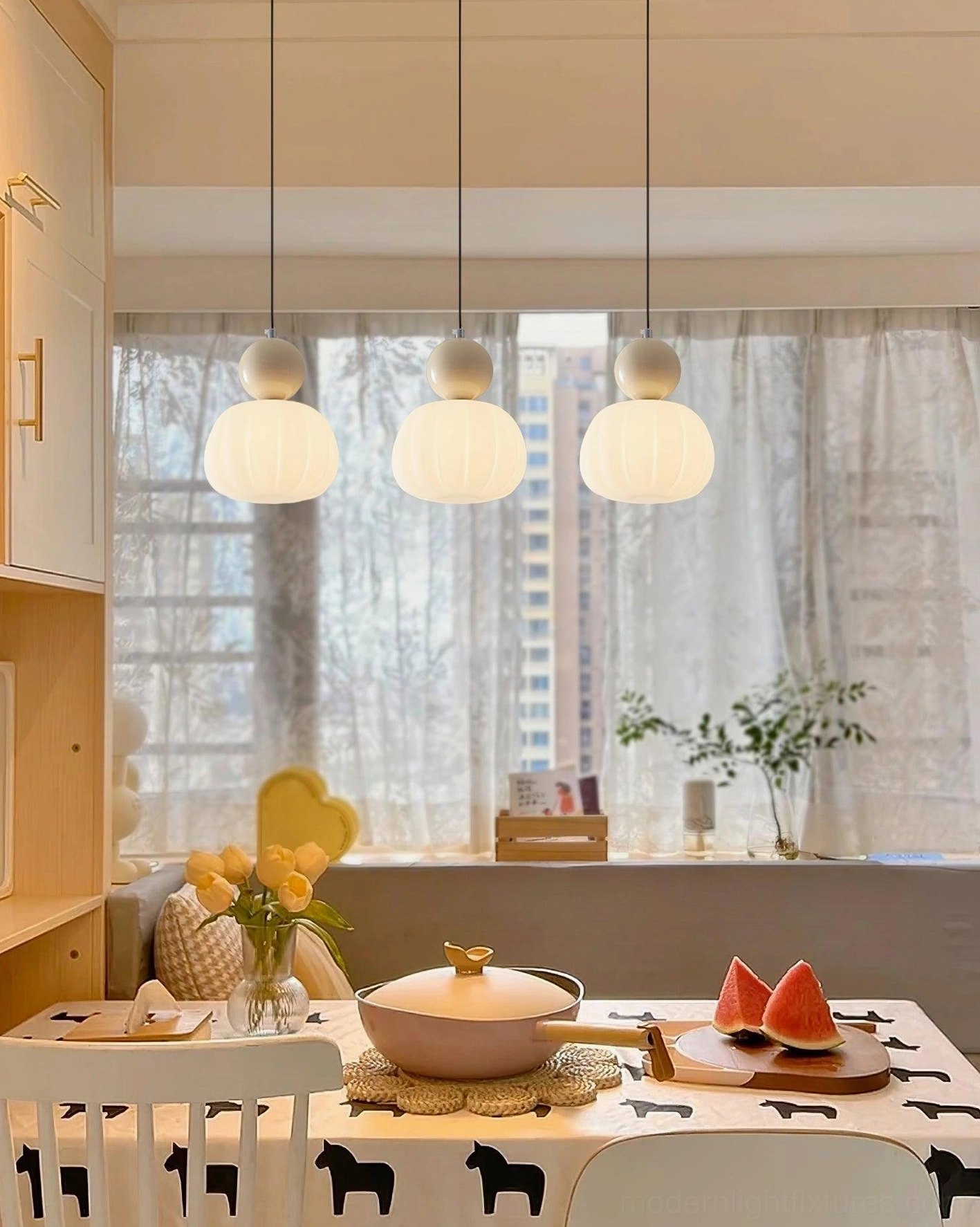 Pair of Morris pendant lights suspended at staggered heights - modern multi-pendant installation design