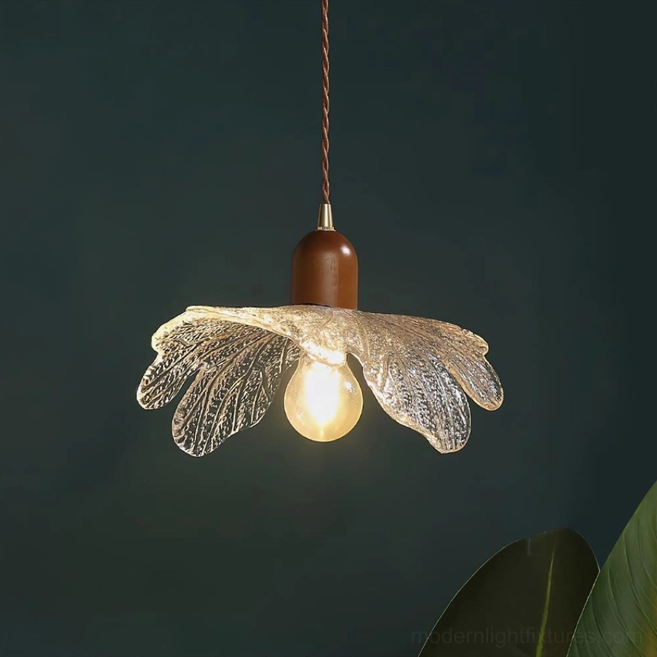 Artisanal glass petal pendant fixture with lit warm bulb, contemporary interior styling