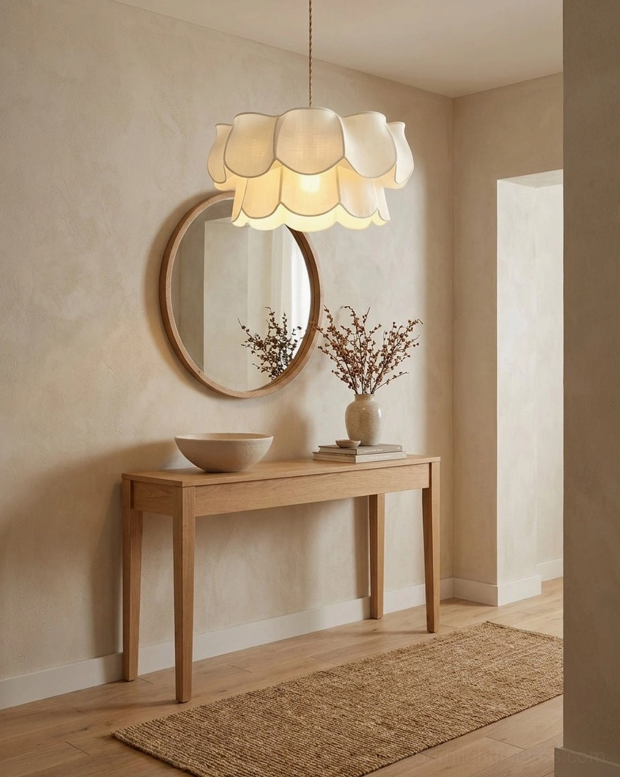 Modern petal pendant light in boho minimalist entryway above wooden console table with round mirror, fabric shade creating warm welcoming glow