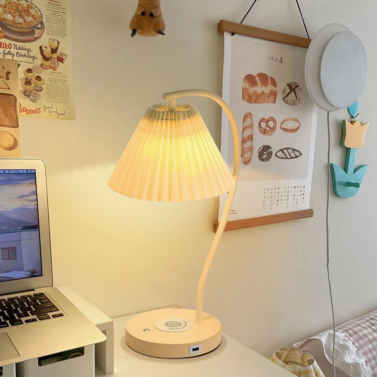 Contemporary pleated table lamp placed beside laptop in modern home office